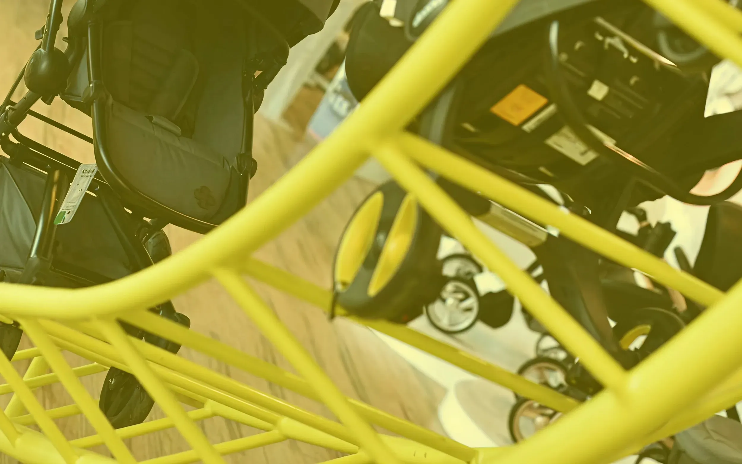 Skyne, a branding agency, designed the Stroller Park interior, showcasing strollers on a yellow, rollercoaster-inspired display structure, for interactive product exploration and unique branding.