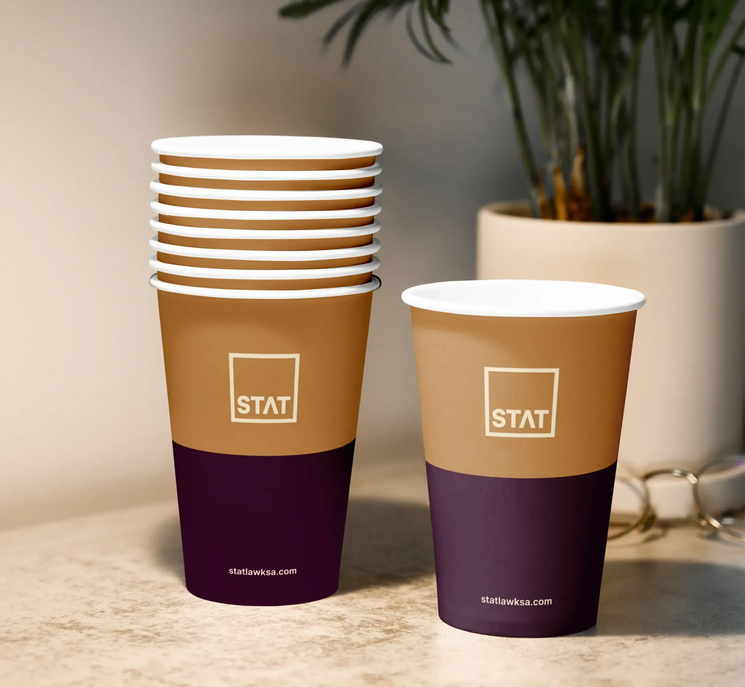  STAT Law branded coffee cups, demonstrating consistent brand application across touchpoints, a service provided by Skyne, a branding agency.