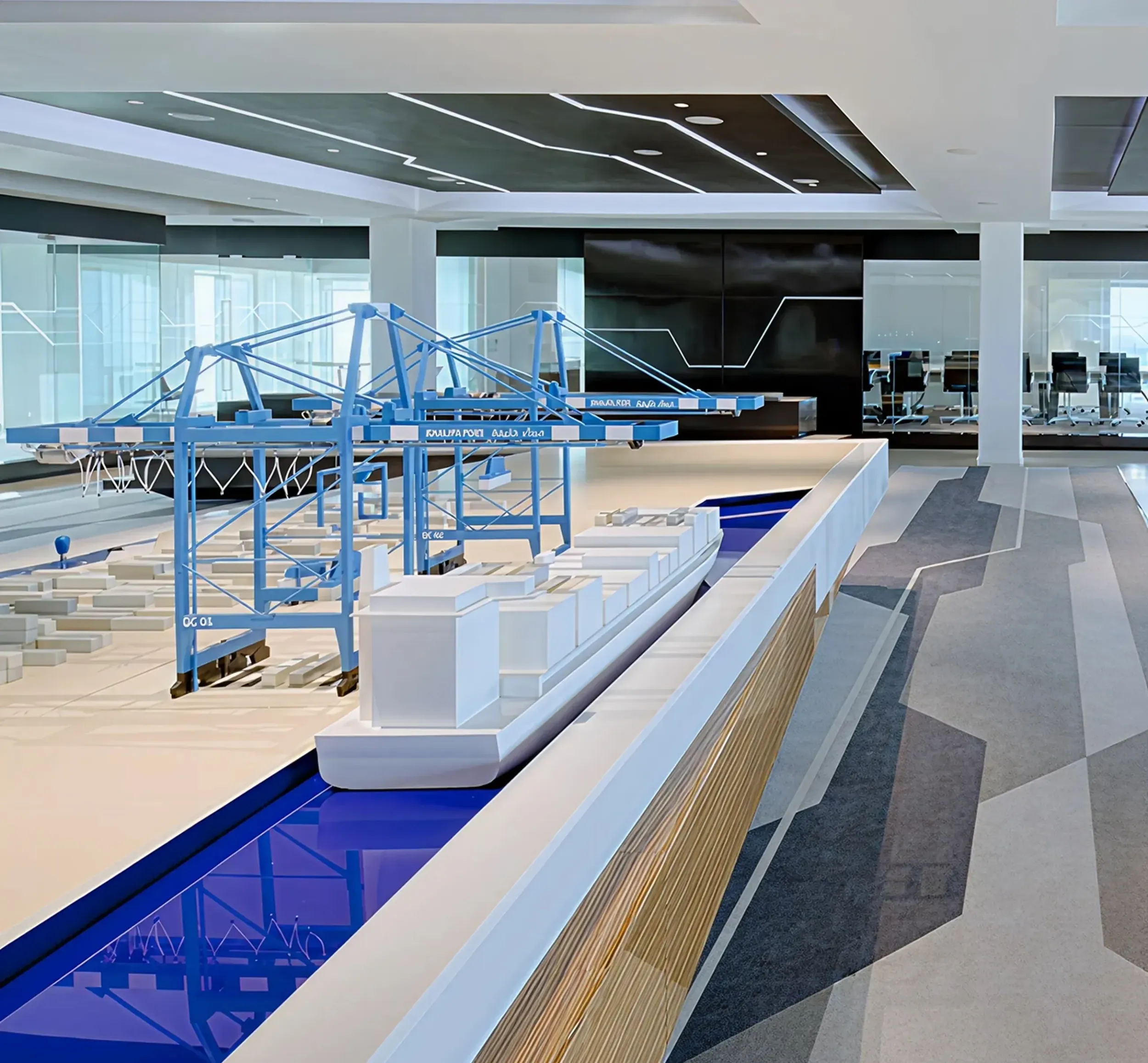Miniature model of Khalifa Port Container Terminal with blue gantry cranes and cargo ship. Skyne, a branding agency, provides comprehensive branding and visual communication for logistics and port operators in Dubai, Riyadh, and Jeddah.