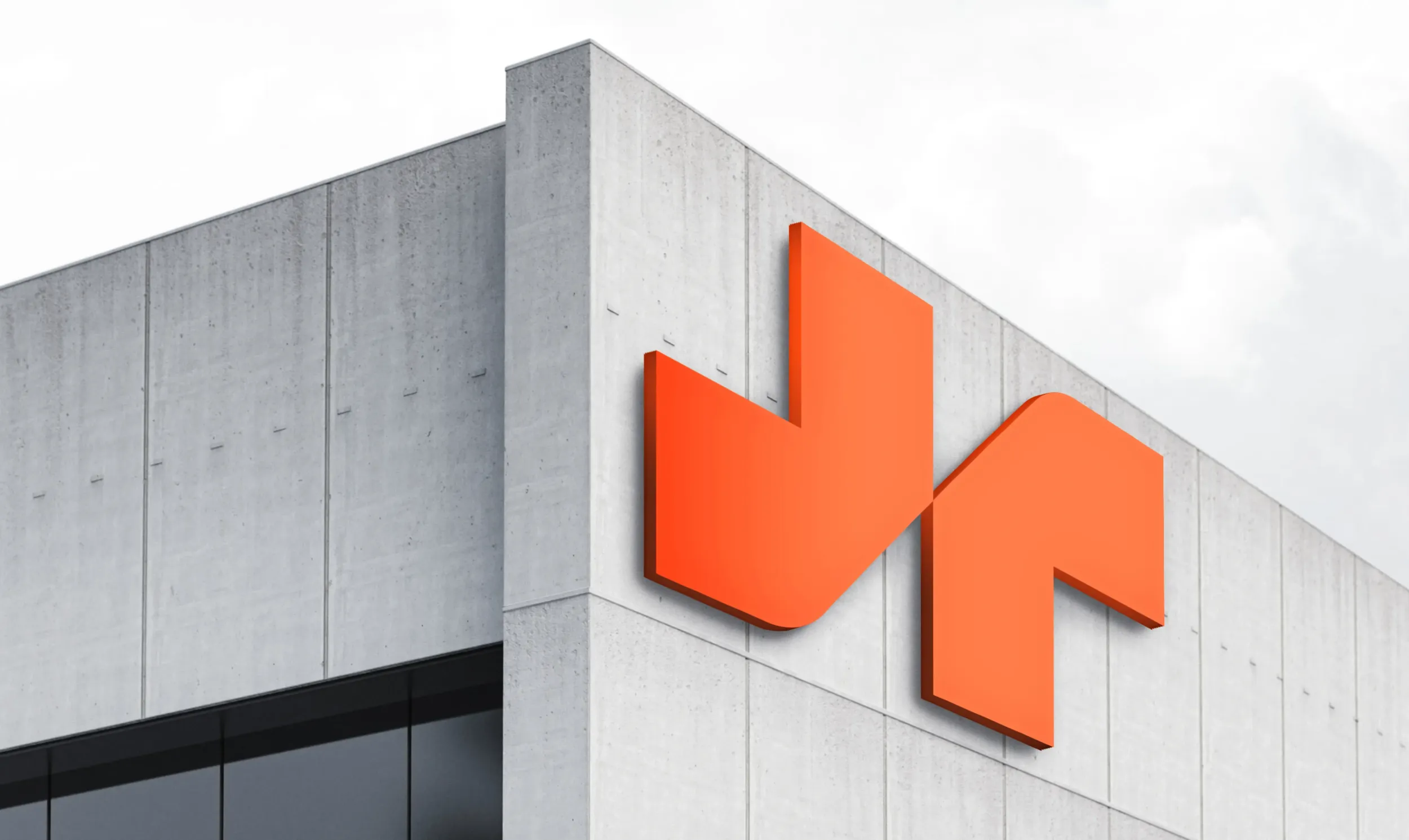 Large orange MS Metals logo on a modern concrete building, showcasing strong brand presence and architectural integration by Skyne, a creative agency in Dubai and Riyadh.