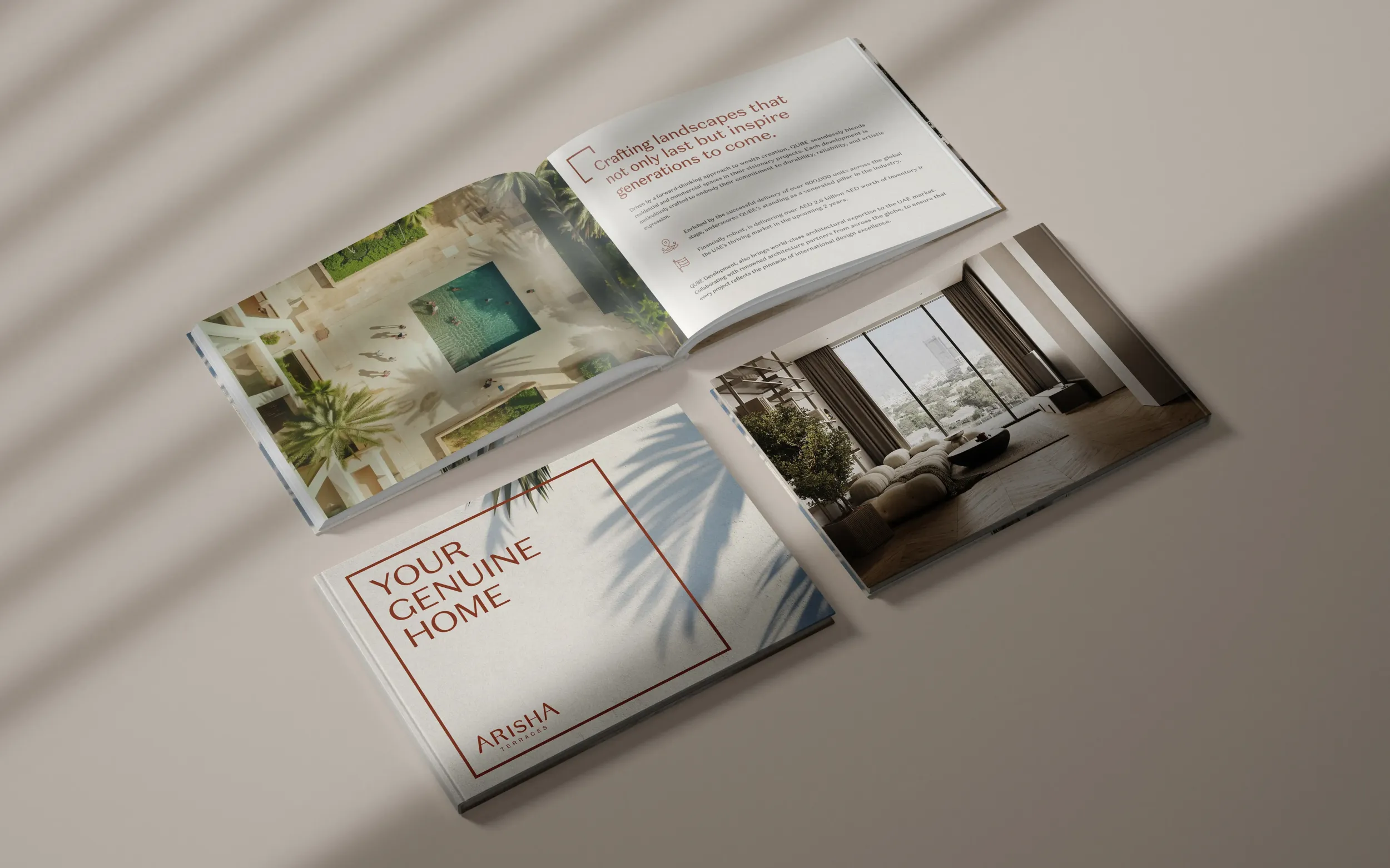 Flat lay of Arisha Terraces marketing collateral, including a brochure and booklet. Skyne develops integrated marketing materials for real estate developments in Dubai, Riyadh, and Jeddah.