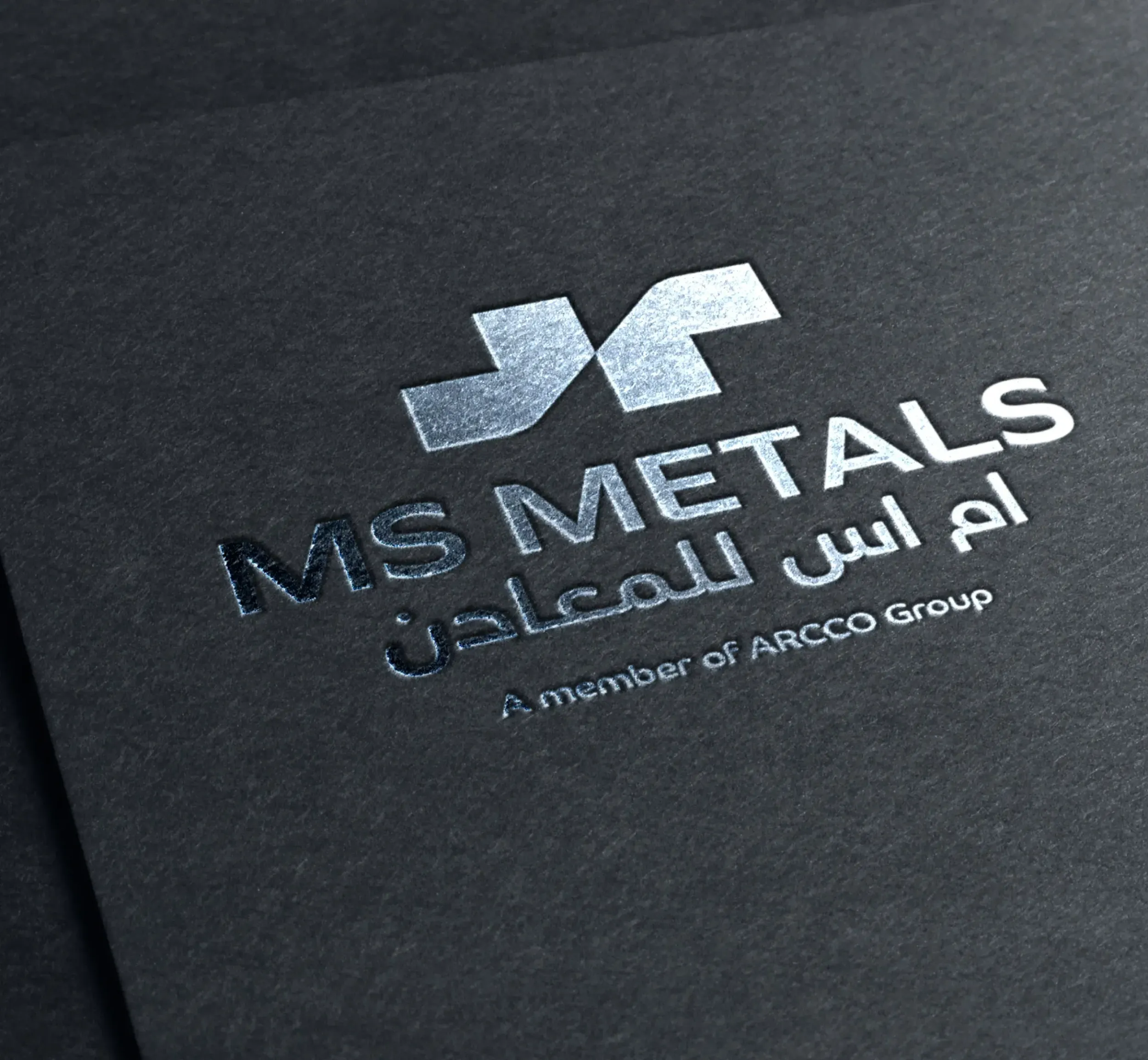 Embossed MS Metals logo on a dark textured surface, showcasing premium branding and attention to detail by Skyne, a creative agency.