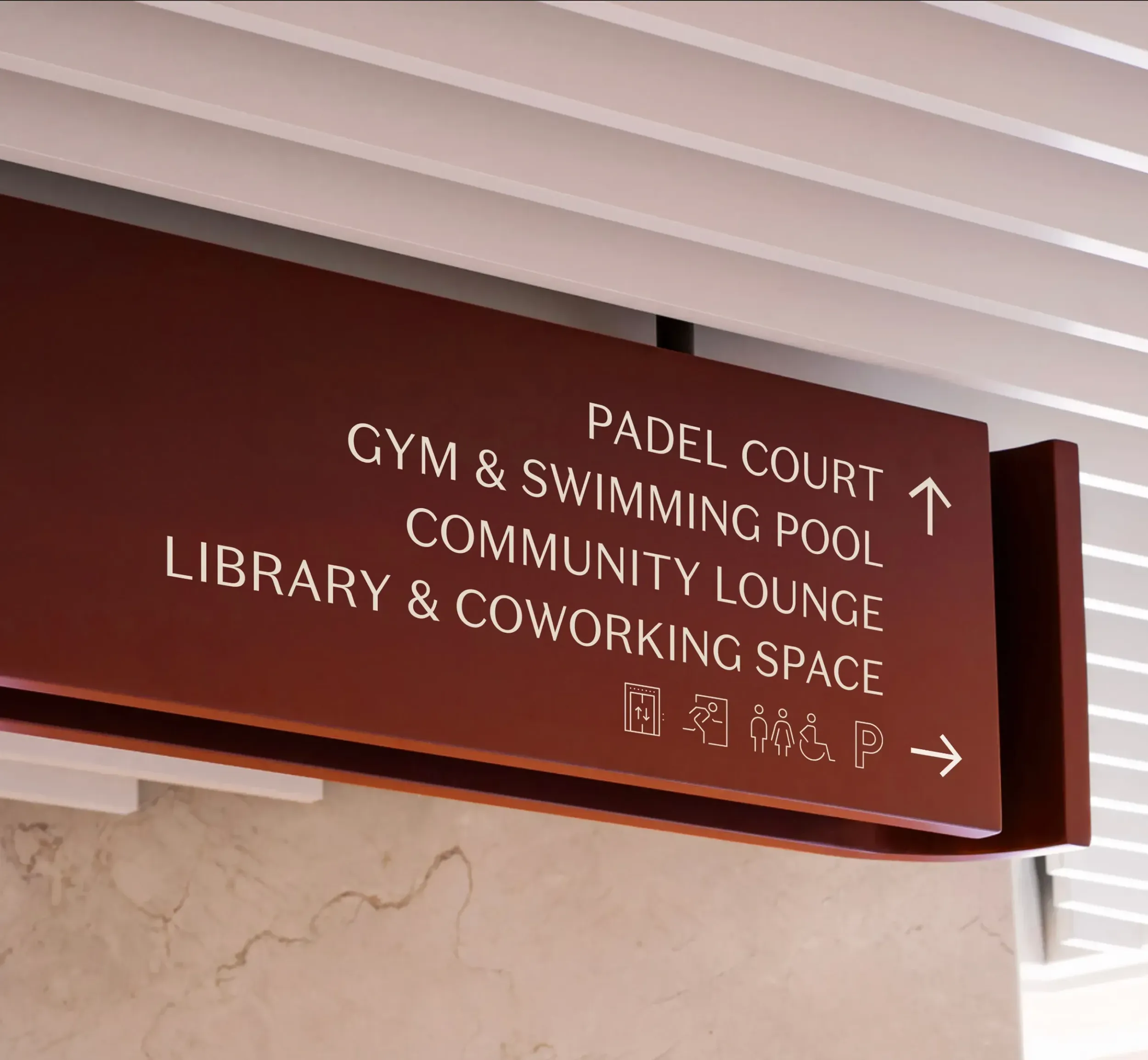Interior directional sign in Arisha Terraces listing amenities like Padel Court, Gym, and Community Lounge. Skyne, a branding agency, develops detailed branding and wayfinding solutions for residential projects in Dubai, Riyadh, and Jeddah.