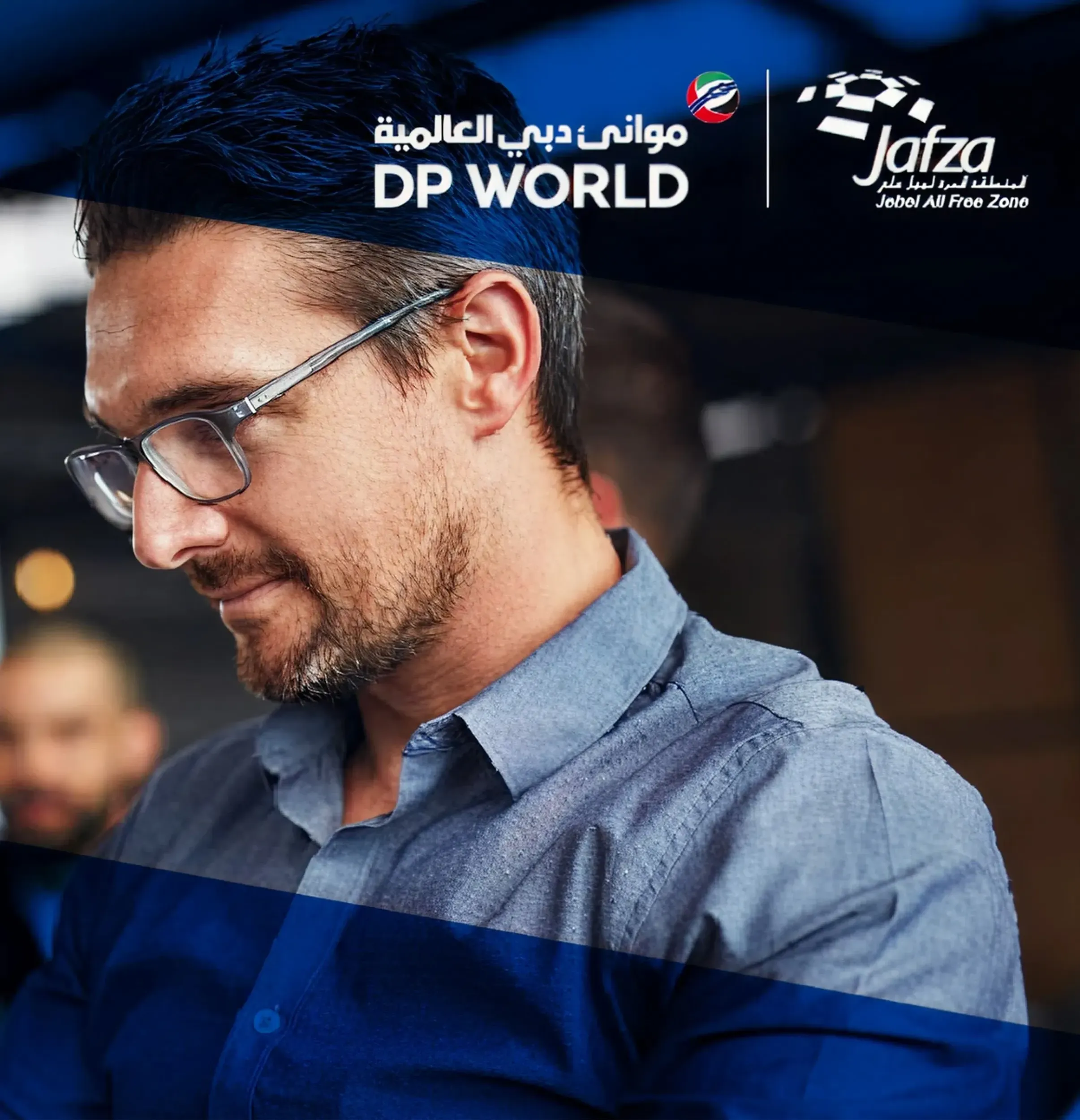 A businessman looking at a tablet, with DP World and JAFZA logos, representing the strategic partnership and Skyne's branding efforts for a leading global trade and logistics entity.