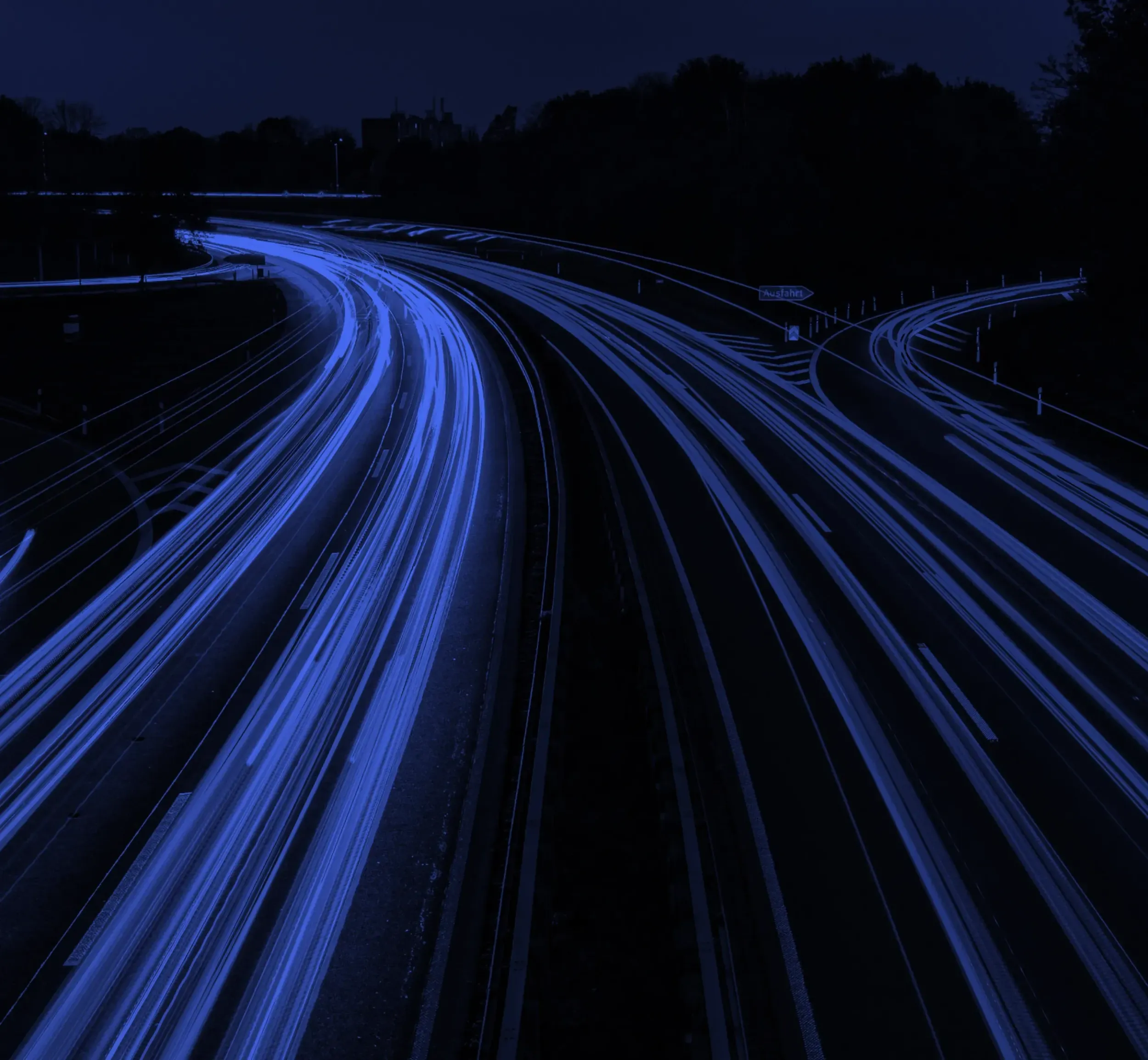 Nighttime highway scene with blue light trails, representing the dynamic and innovative identity of SRTIP, developed by Skyne branding agency