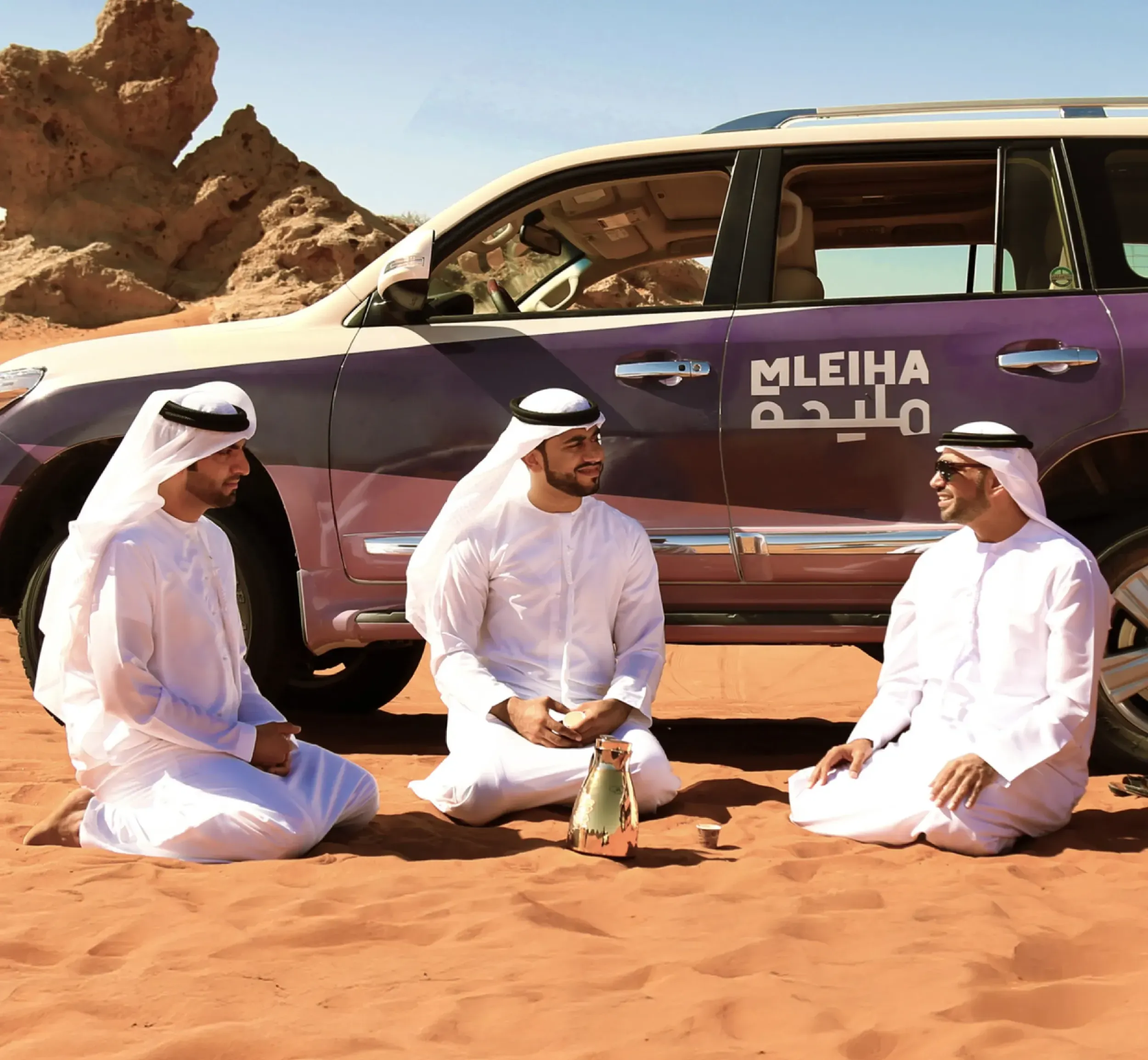 Skyne, a branding agency in Jeddah, showcases Mleiha-branded vehicles in the desert, emphasizing the destination's immersive experience and effective branding strategy.