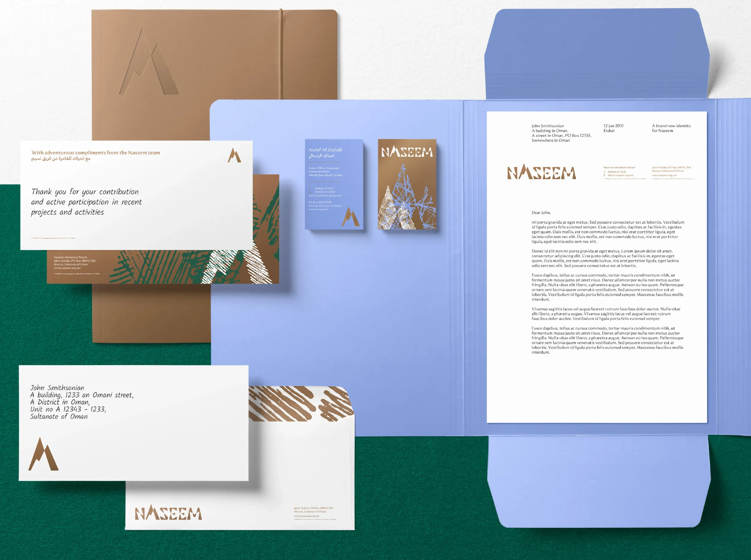 Flat lay of Naseem branding collateral: folders, letterheads, business cards, envelopes with logo and mountain design. This demonstrates Skyne's branding and packaging design services for Naseem. 