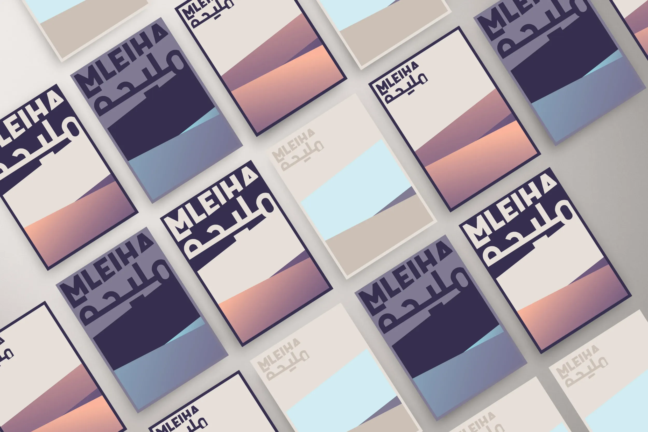 Flat lay of branded cards for Mleiha, featuring modern typography and abstract desert landscape illustrations in earthy and pastel tones