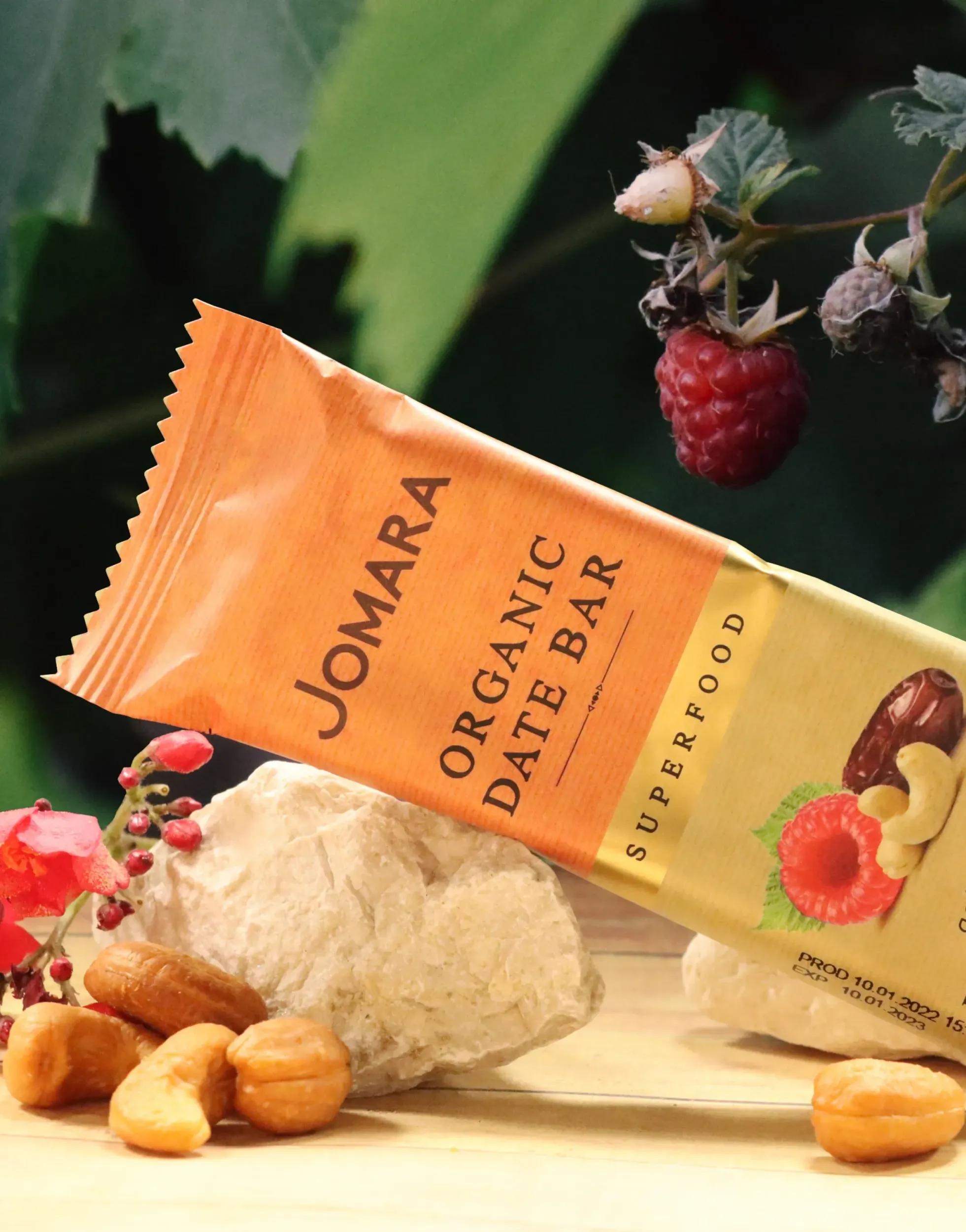 Jomara organic date bar with raspberry and cashew, tropical brand visual by Skyne branding agency