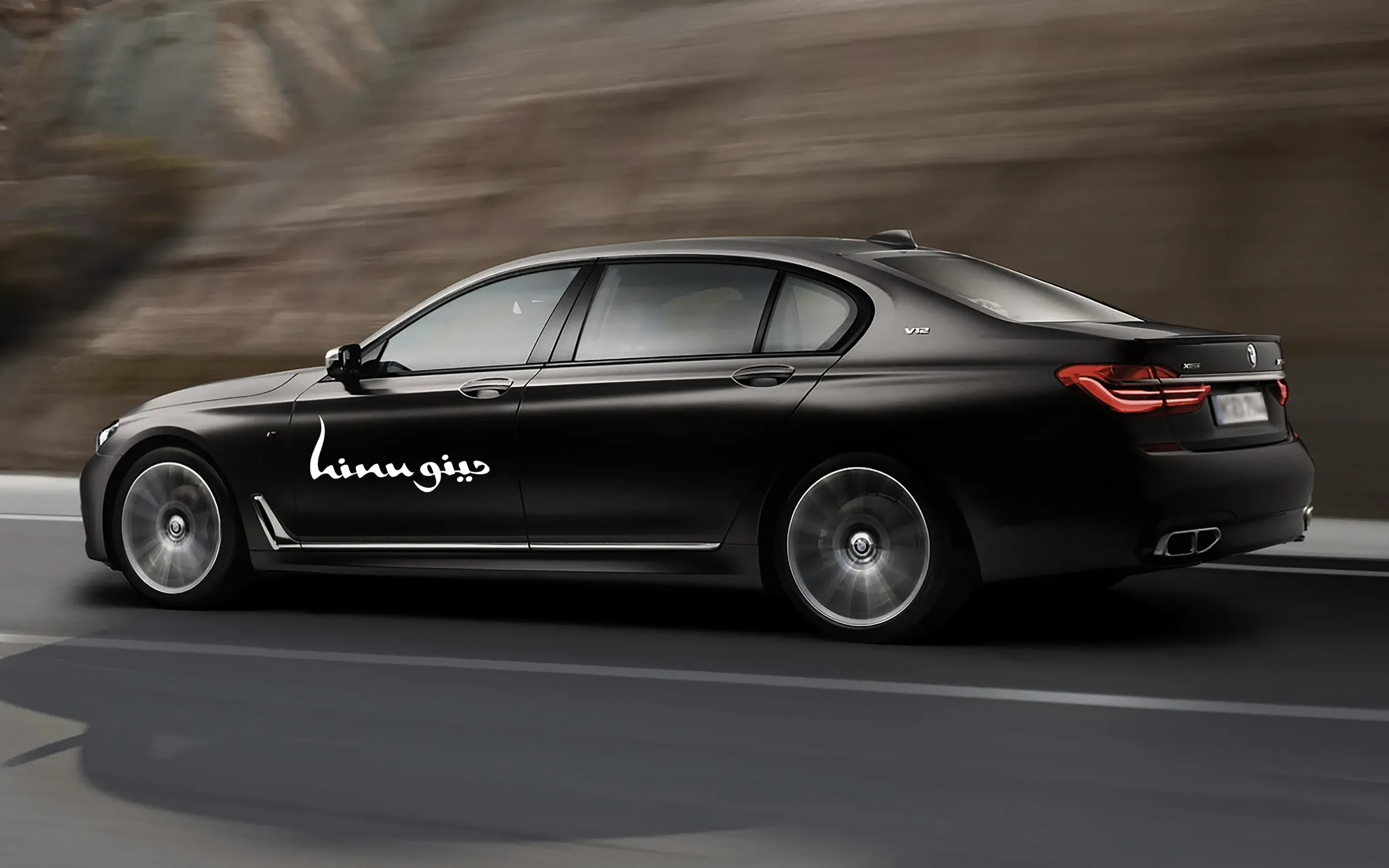Black luxury car with Hinu Bay logo on the side, representing premium branding and high-end services. Skyne, a branding agency, excels in creating sophisticated brand identitie for luxury brands in Dubai, Riyadh, and Jeddah.