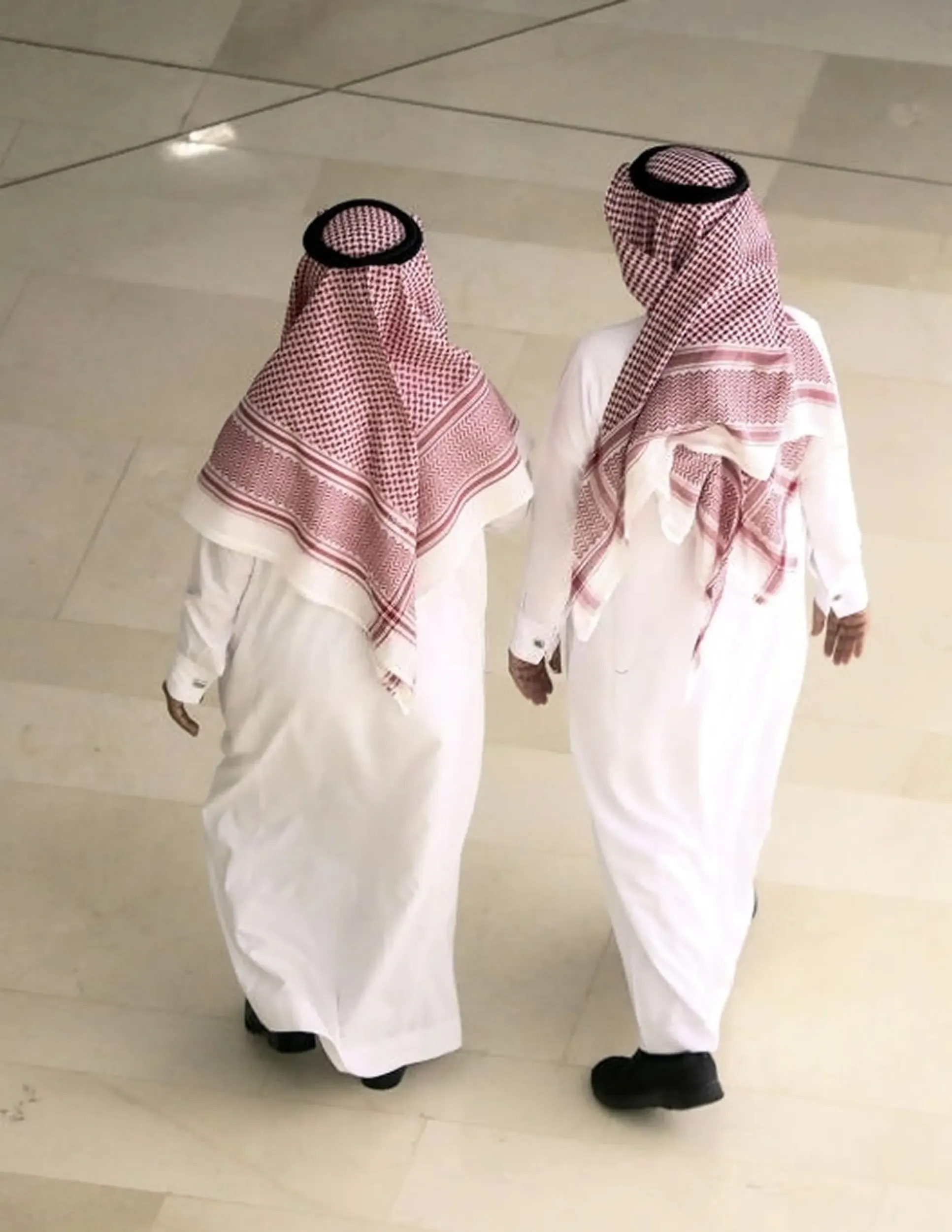 Two men in traditional Saudi attire, representing the target audience for Yaqeen Capital. Skyne, a creative agency, focused on a human-centric approach for the rebranding. 