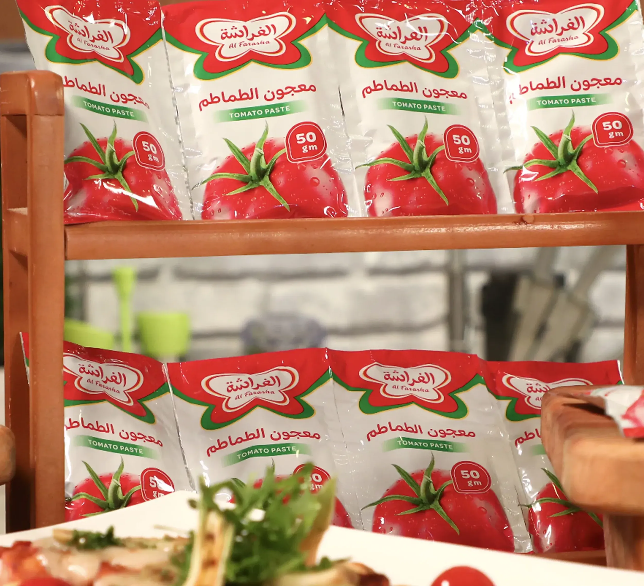 Al Farasha tomato paste pouches on a shelf, showcasing the packaging design. Skyne, a creative agency, ensured visibility in retail.