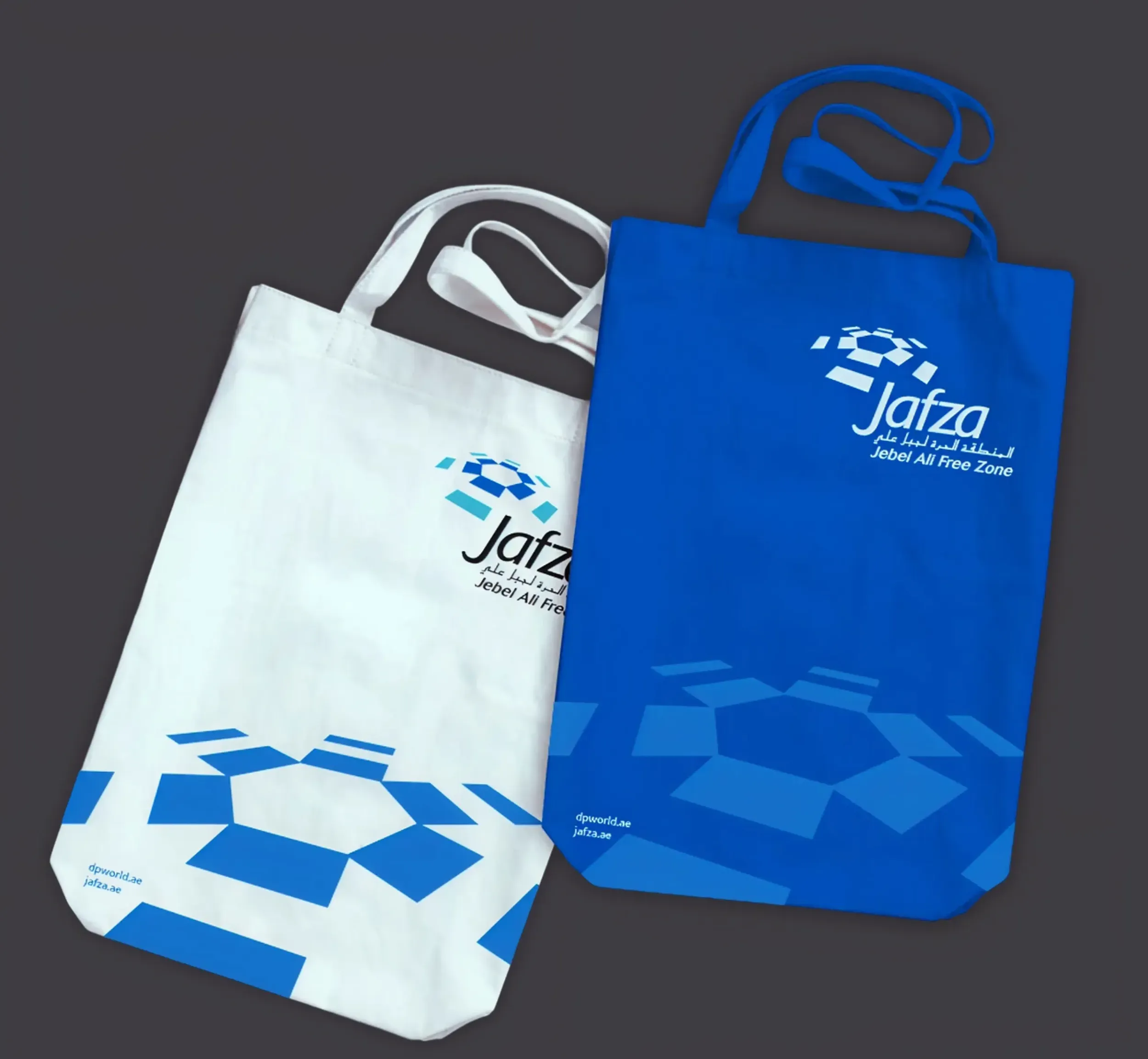JAFZA branded tote bags in white and blue, demonstrating Skyne's comprehensive branding and packaging design solutions for promotional materials.