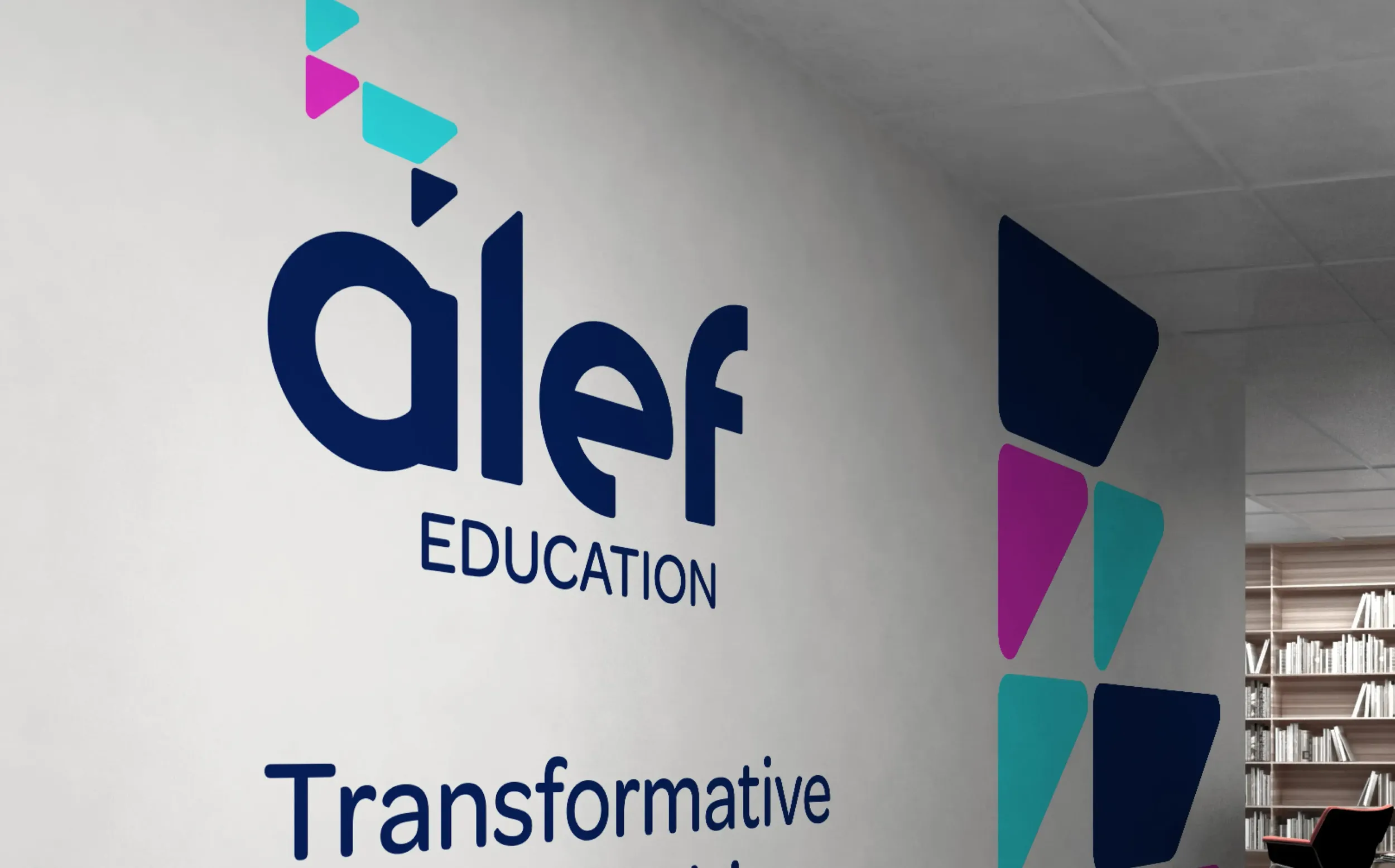 Alef Education logo on an office wall with geometric accents and the tagline 'Transformative' partially visible