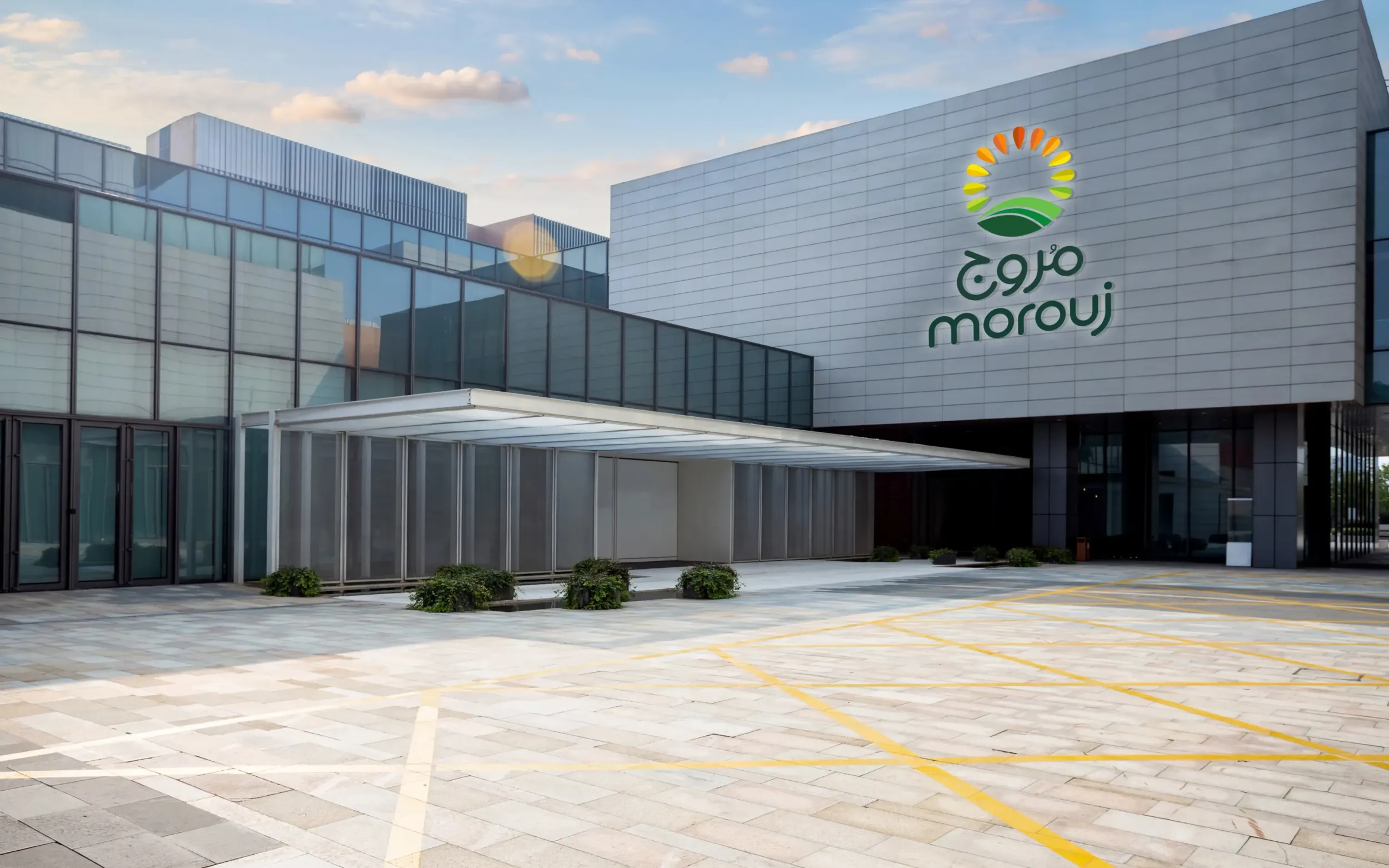 Exterior of Marooj corporate building with logo on facade, architectural branding by Skyne branding agency