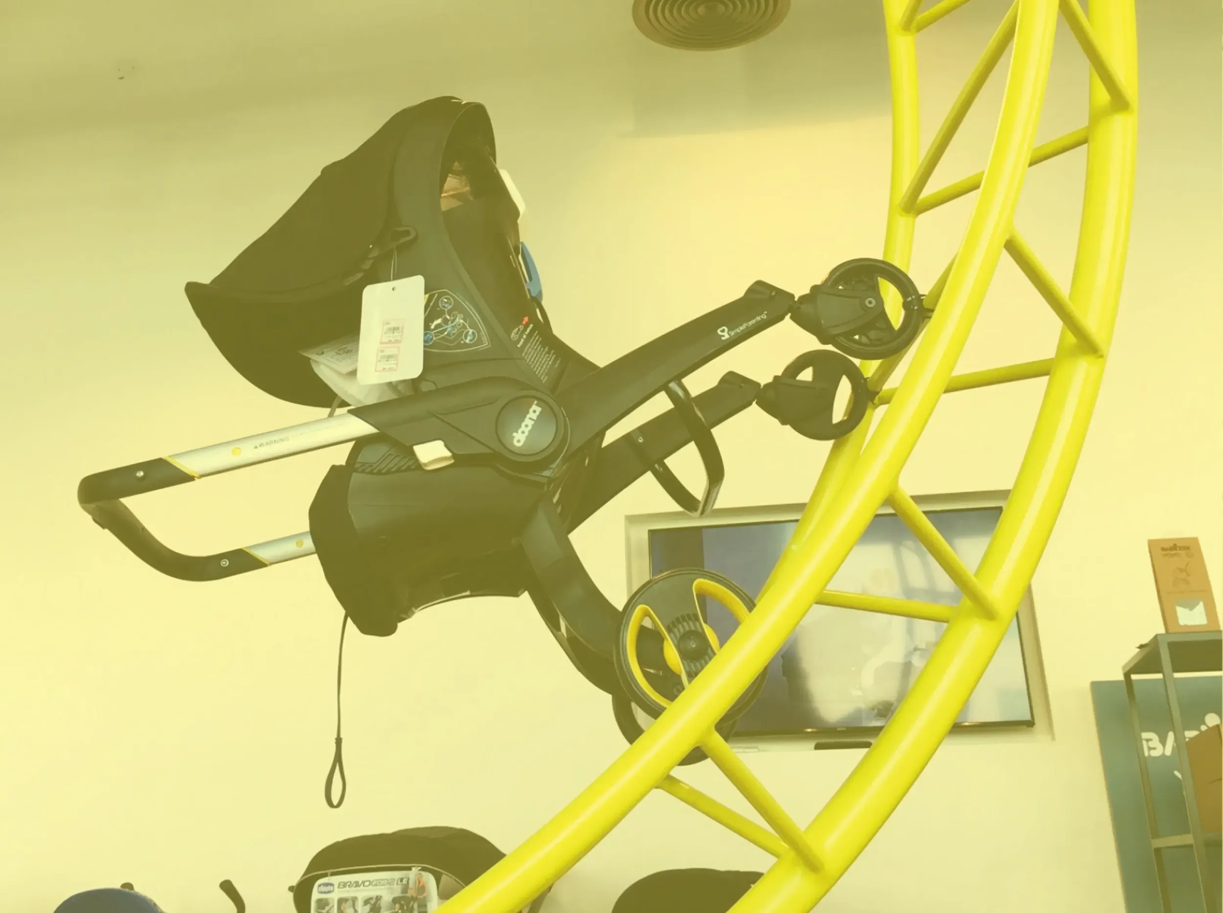 Skyne, a branding agency, showcases the Stroller Park display, featuring a car seat on a yellow rollercoaster-like structure, demonstrating innovative product testing and immersive branding.