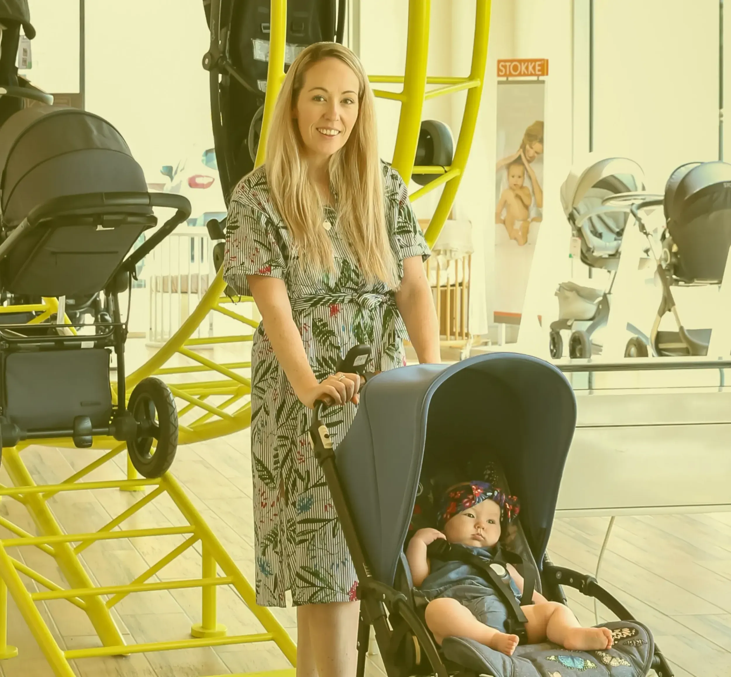 Skyne, a creative agency in Dubai, highlights the Stroller Park experience, with a mother and baby testing a stroller on the innovative in-store track, showcasing effective branding and retail design.