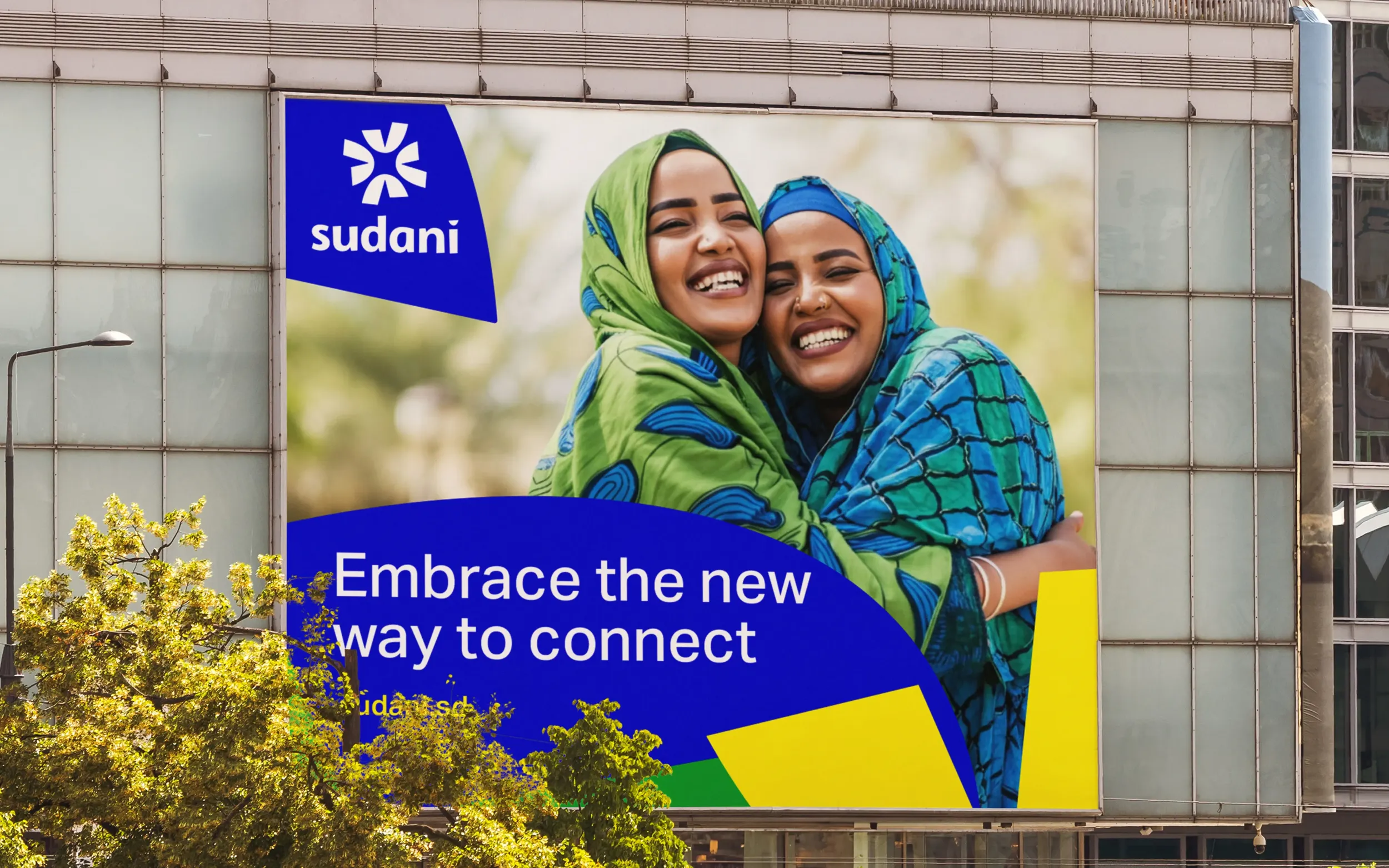 Sudani billboard advertisement, featuring two smiling women, reflecting Skyne's creative agency work in telecommunications marketing and brand visibility in Dubai, Riyadh, and Jeddah.