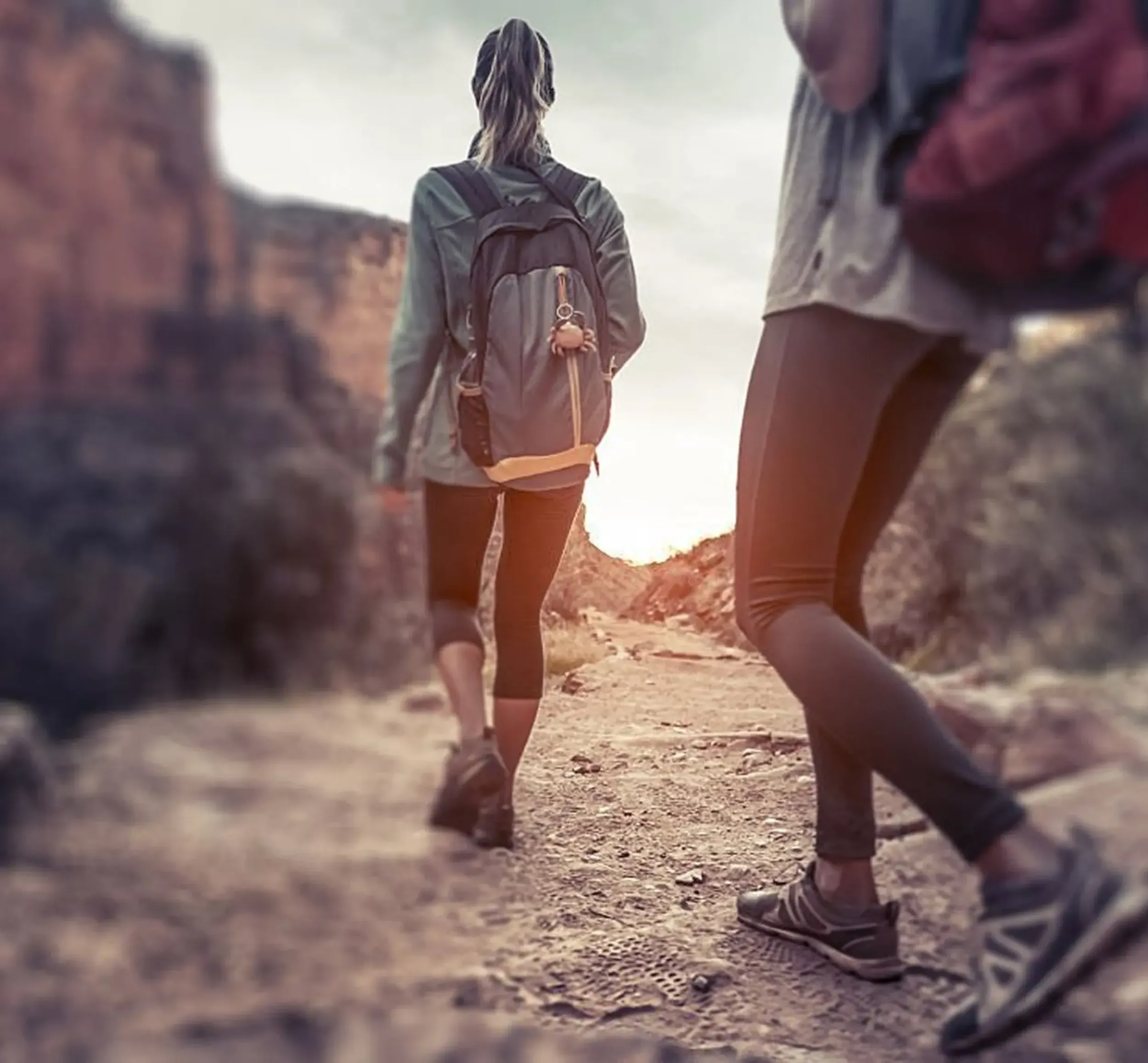 Two people hiking in the mountains near Al Rafisah Dam, representing the adventure and exploration opportunities at the destination. This image is used in the branding materials developed by Skyne to attract eco-conscious travelers.