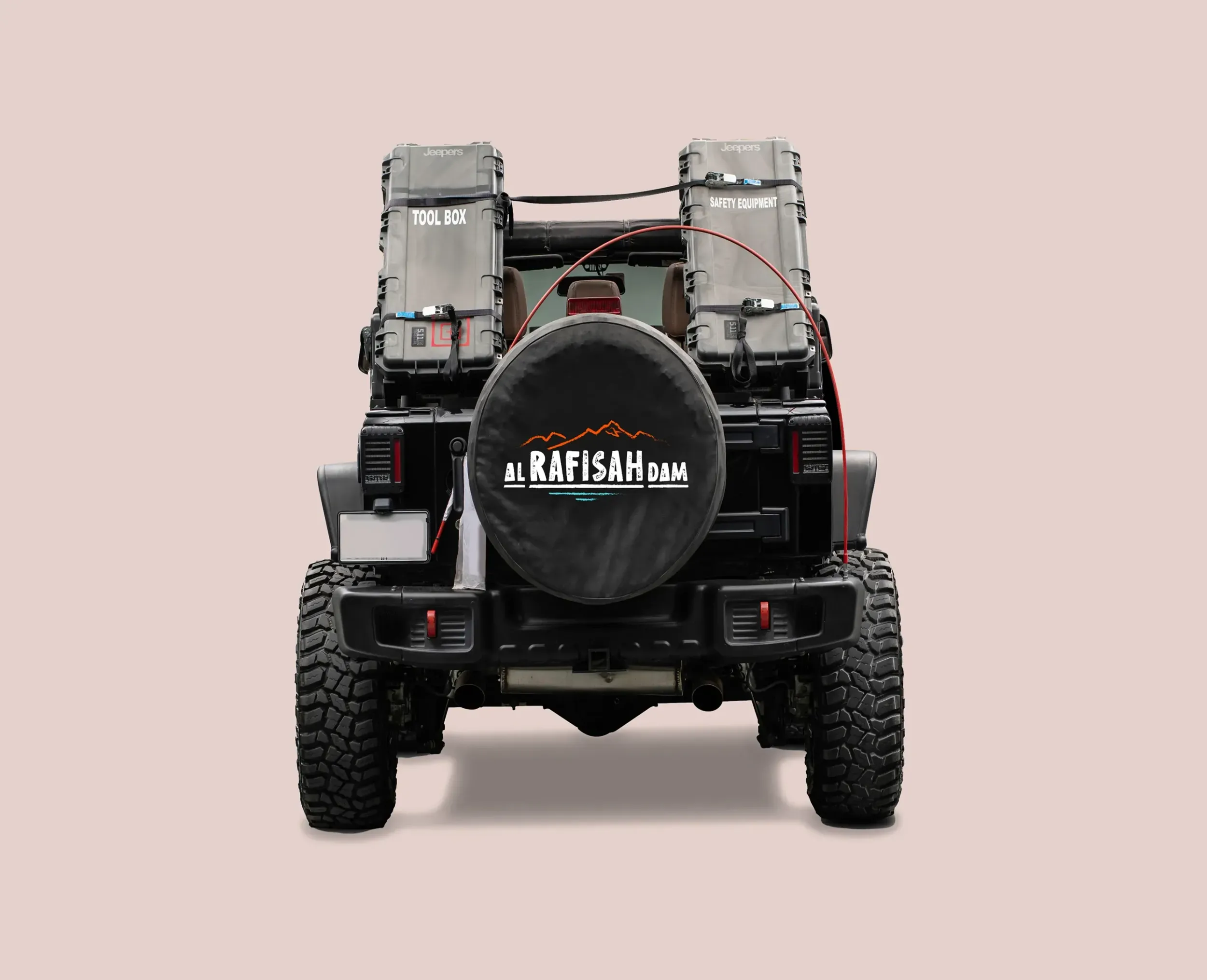 A branded Jeep with the Al Rafisah Dam logo on the spare tire cover, ready for an off-road adventure. This image, part of a campaign by Skyne, highlights the destination's appeal for explorers and outdoor enthusiasts.