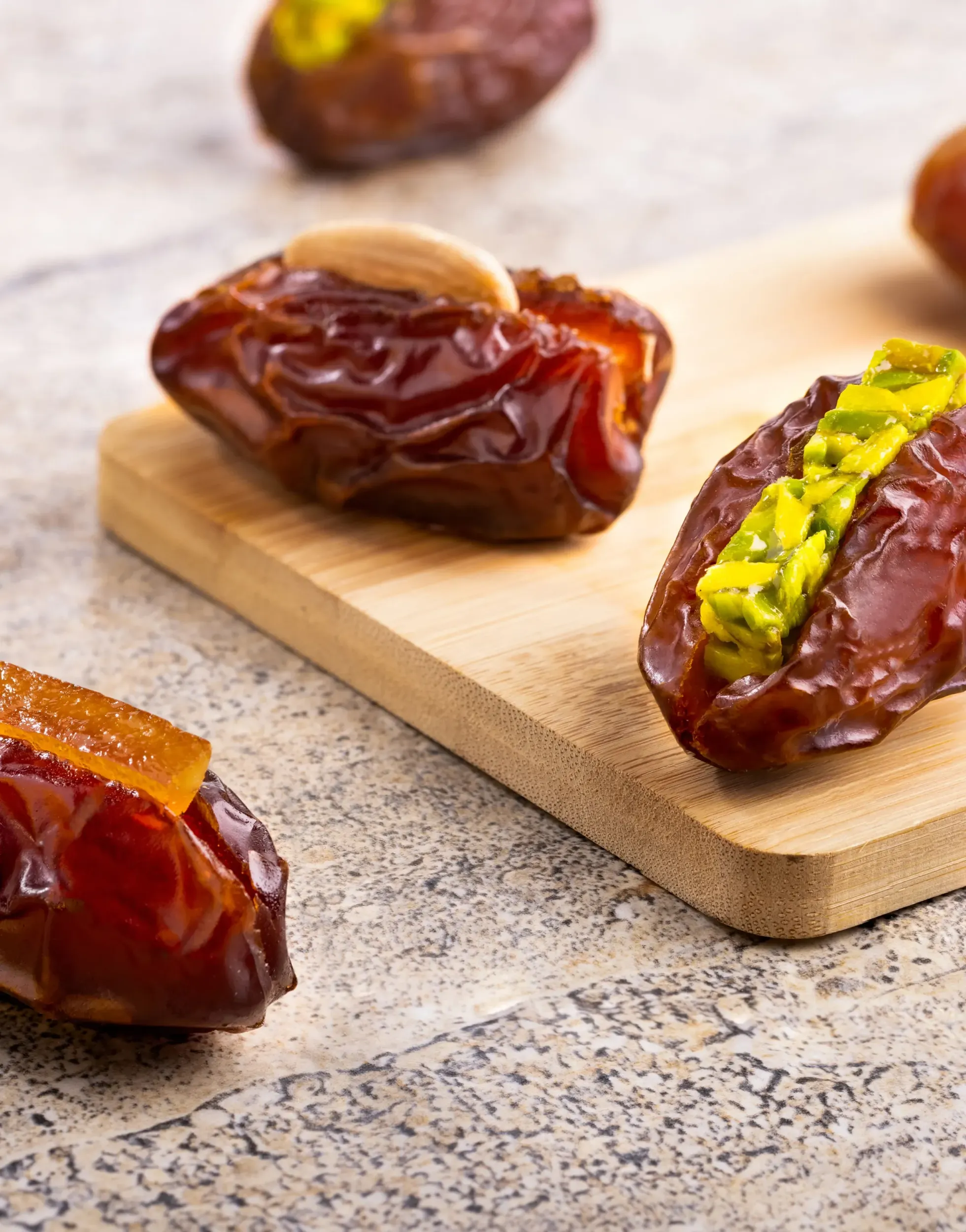 Premium stuffed dates with nuts and fruit on stone surface, product styling by Skyne branding agency