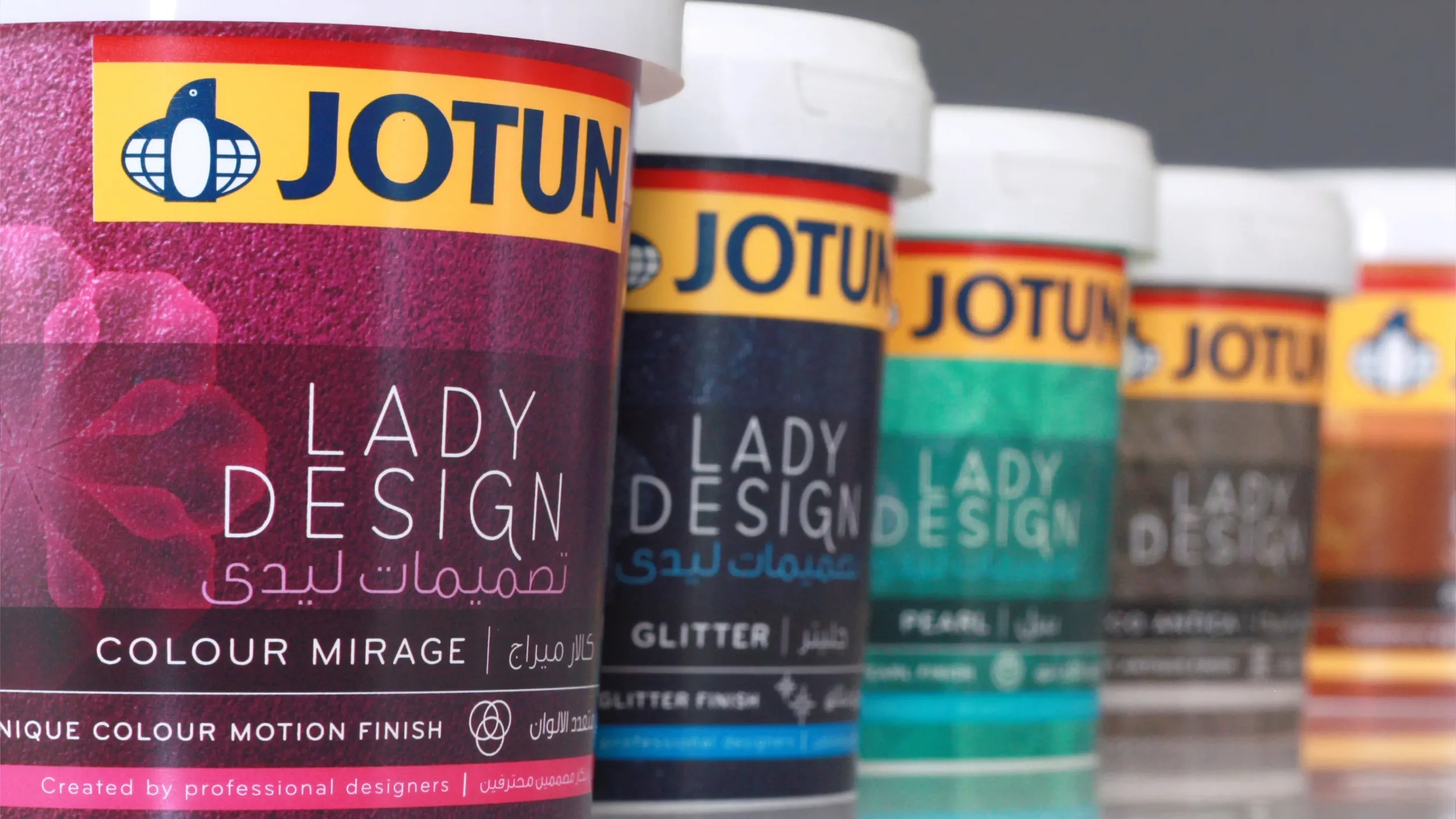 A row of Jotun Lady Design paint cans, illustrating comprehensive branding and packaging design solutions from Skyne, a top branding agency.